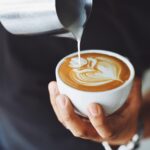 Pouring milk in the coffee