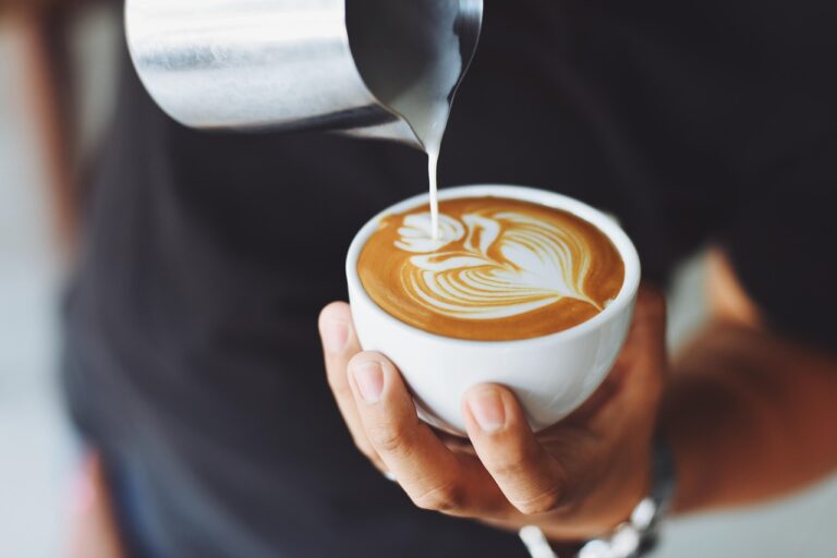 Pouring milk in the coffee